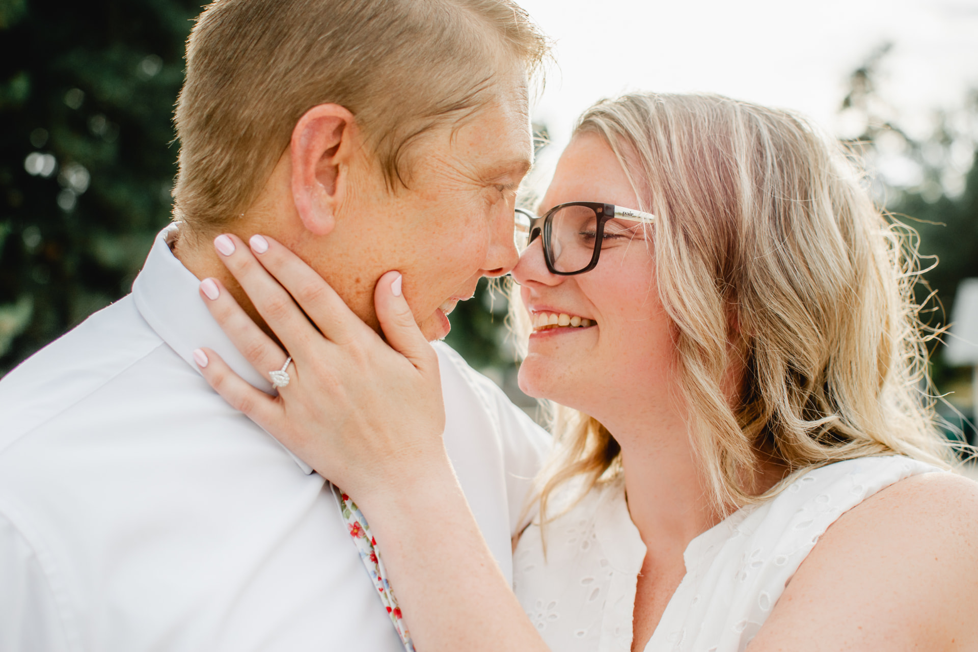Engaged couple nose to nose in golden evening light
