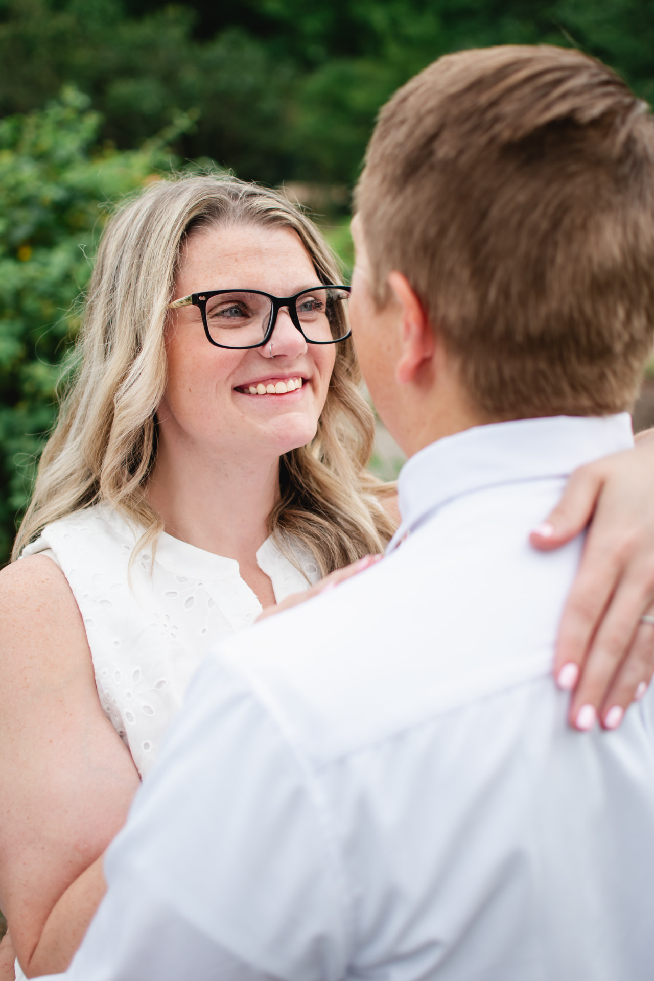Bride-to-be smiling at her fiancé during their engagement session